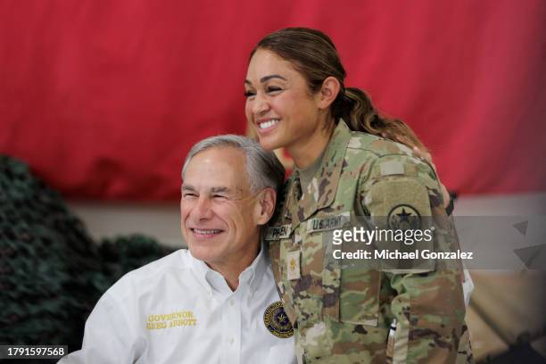 Texas Governor Greg Abbott poses for a photo with a service member in the Texas National Guard at the South Texas International airport on November...