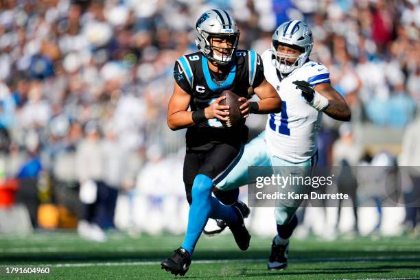 Bryce Young of the Carolina Panthers runs the ball during an NFL football game against the Dallas Cowboys at Bank of America Stadium on November 19,...