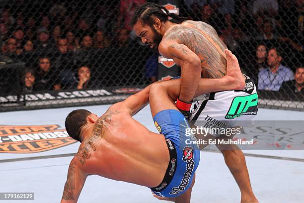 Benson Henderson blocks a kick from Anthony Pettis in their UFC lightweight championship bout at BMO Harris Bradley Center on August 31, 2013 in...