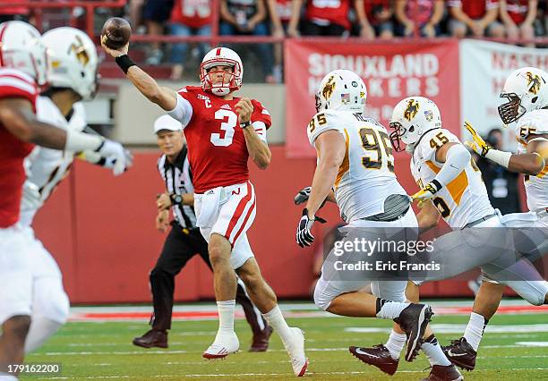 Quarterback Taylor Martinez of the Nebraska Cornhuskers throws over the Wyoming Cowboys during their game at Memorial Stadium on August 31, 2013 in...