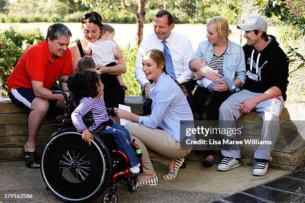 Opposition Leader Tony Abbott and daughter Bridget Abbott speak with parents and children at Bear Cottage in Sydney on September 1, 2013 in Sydney,...