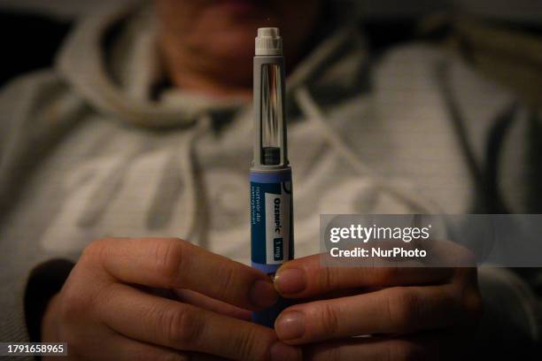 Woman holds an Ozempic needle shot pen in this photograph taken in Warsaw, Poland on 19 November, 2023. German regulator BfArM is considering banning...