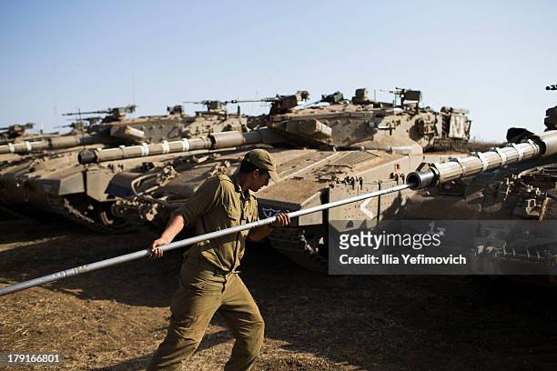 Israeli soldiers seen working on his tank on September 1, 2013 near the border with Syria, in the Israeli-annexed Golan Heights. Tension's are rising...