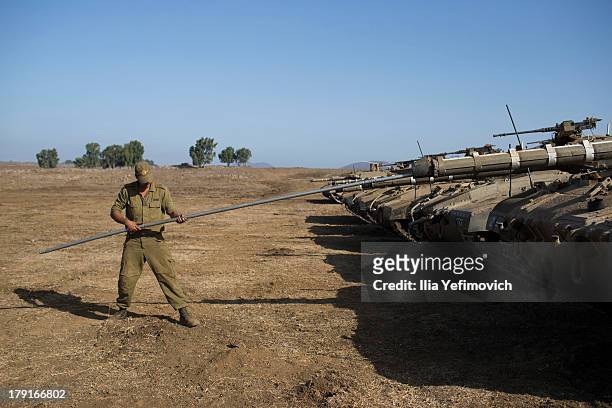 Israeli soldiers seen working on his tank on September 1, 2013 near the border with Syria, in the Israeli-annexed Golan Heights. Tension's are rising...