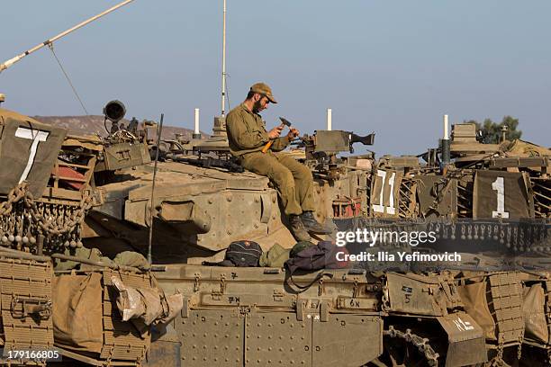 Israeli soldiers seen working on his tank on September 1, 2013 near the border with Syria, in the Israeli-annexed Golan Heights. Tension's are rising...