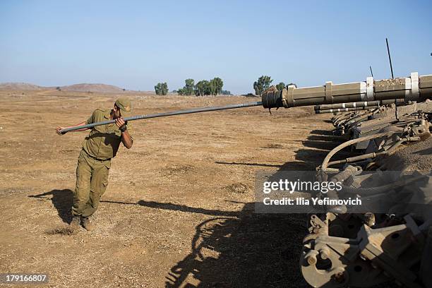 Israeli soldiers seen working on his tank on September 1, 2013 near the border with Syria, in the Israeli-annexed Golan Heights. Tension's are rising...