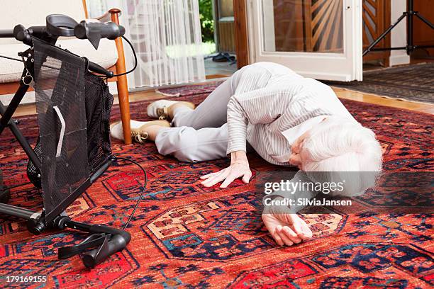 accident senior woman after fall lying on ground - val stockfoto's en -beelden