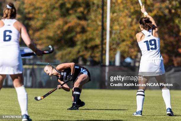 Emily Knight of the Johns Hopkins Blue Jays lifts a pass over two Middlebury defenders during the Division III Field Hockey Championship held at...