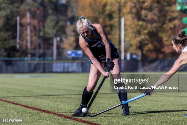 Emily Knight of Johns Hopkins Blue Jays passes over the steal attempt of a Middlebury defender during the Division III Field Hockey Championship held...