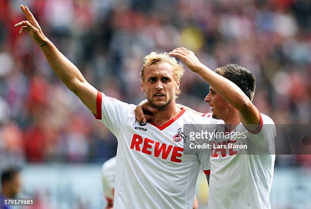 Marcel Risse of Koeln celebrates with team mate Slawomir Peszco after scoring his teams third goal during the Second Bundesliga match between 1. FC...