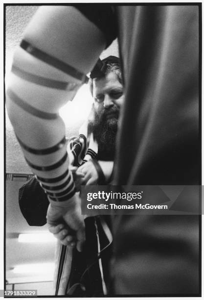 Rabbi Harlig showing a man how to tie tefillin at Chabad of the Inland Empire in Ontario, in California in 2012.