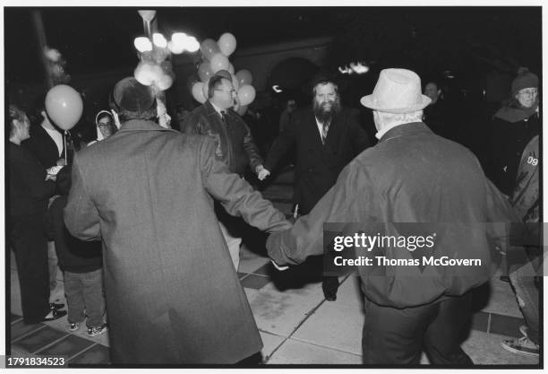 Rabbi Harlig of Chabad of the Inland Empire dancing with men at a Chanukah party in Ontario in California in 2012.