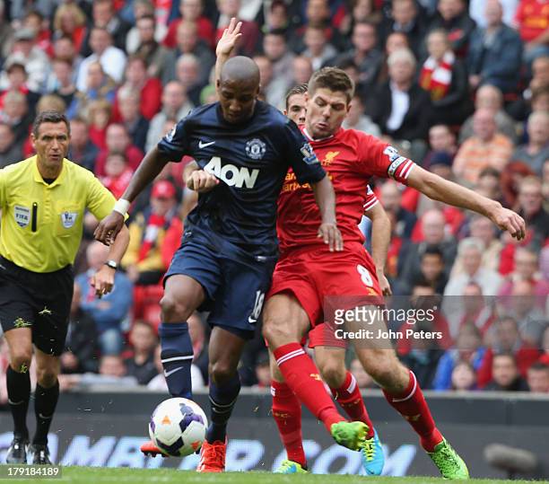 Ashley Young of Manchester United in action with Steven Gerrard of Liverpool during the Barclays Premier League match between Liverpool and...