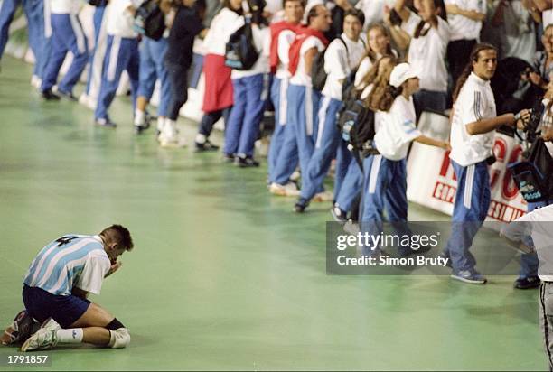 Christian Lares of Argentina kneels to celebrate victory against the United States during the Pan American Games. Mandatory Credit: Simon Bruty...