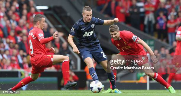 Tom Cleverley of Manchester United in action with Iago Aspas and Steven Gerrard of Liverpool during the Barclays Premier League match between...