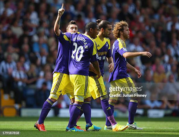 Pablo Hernandez of Swansea celebrates with team mates after scoring their second goal during the Barclays Premier League match between West Bromwich...
