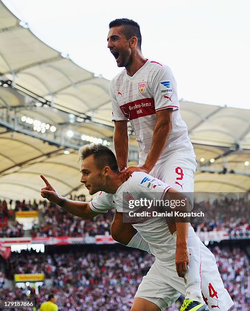 Alexandru Maxim of Stuttgart celebrates scoring his team's third goal with team-mate Vedad Ibisevic during the Bundesliga match between VfB Stuttgart...