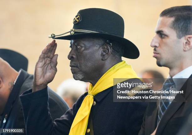 Buffalo Solider salutes during the singing of the National Anthem before an event recognizing the legacy of the soldiers from the 3rd Battalion, 24th...