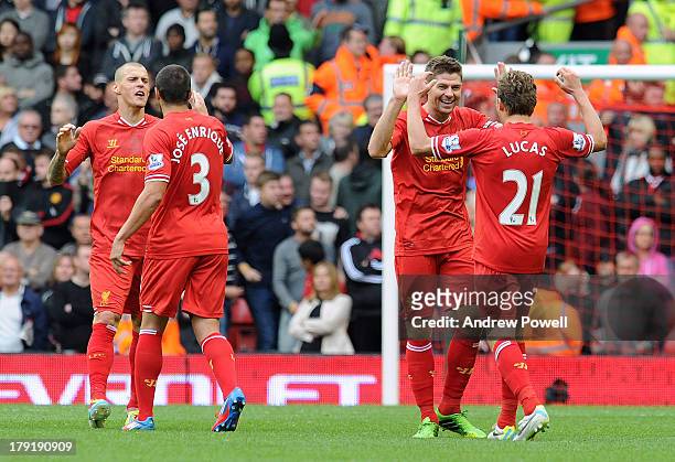 Martin Skrtel, Jose Enrique, Steven Gerrard and Lucas Leiva of Liverpool celebrate their win at the end of the Barclays Premier League match between...