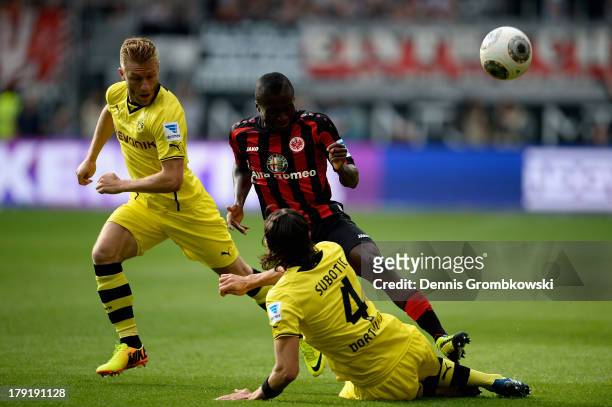 Constant Djapka of Eintracht Frankfurt is challenged by Jakub Blaszczykowski and Neven Subotic of Borussia Dortmund during the Bundesliga match...