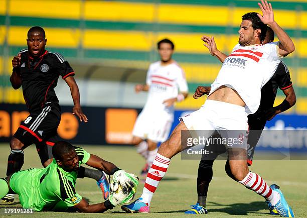 South Africa's Oralando Pirates goalkeeper Senzo Robert Meyima catches the ball in front of Egypt's Zamalek player Ahmad Fathy during their CAF...