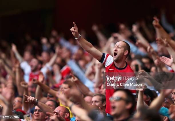 Arsenal fans celebrate victory after the Barclays Premier League match between Arsenal and Tottenham Hotspur at Emirates Stadium on September 01,...
