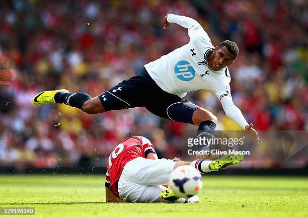 Etienne Capoue of Spurs leaps over a challenge from Aaron Ramsey of Arsenal during the Barclays Premier League match between Arsenal and Tottenham...