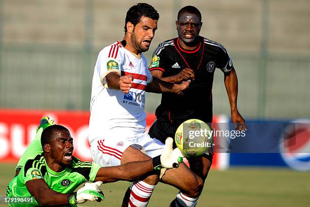 South Africa's Oralando Pirates goalkeeper Senzo Robert Meyima catches the ball in front of Egypt's Zamalek player Ahmad Fathy as Lucky Letlhohonolo...