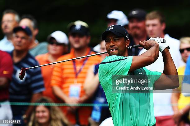 Tiger Woods of the USA plays his shot from the first tee during the third round of the Deutsche Bank Championship at TPC Boston on September 1, 2013...