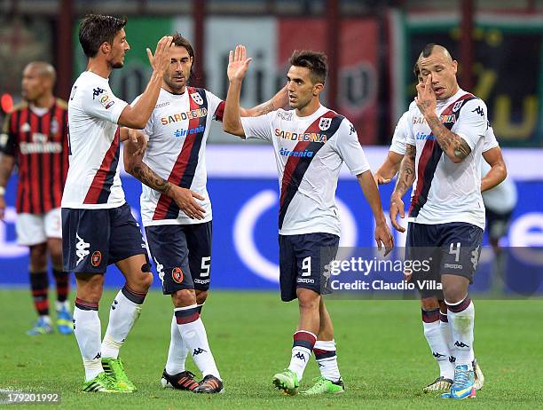 Marco Sau of Cagliari Calcio celebrates with team-mates after scoring his team's first goal during the Serie A match between AC Milan and Cagliari...