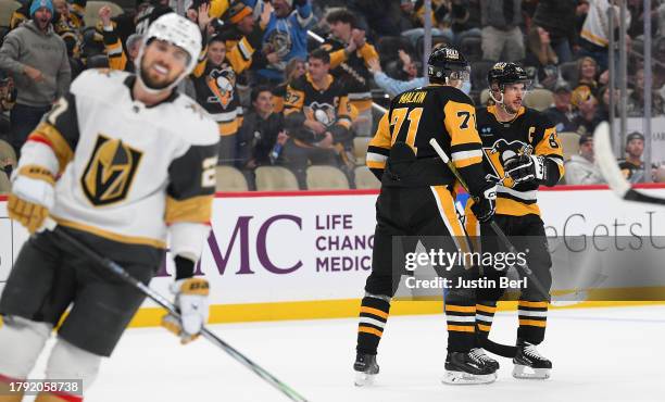 Evgeni Malkin of the Pittsburgh Penguins celebrates with Sidney Crosby after scoring an empty net goal in the third period during the game against...