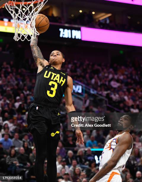 Keyonte George of the Utah Jazz dunks in front of Kevin Durant of the Phoenix Suns during the first half of a game at Delta Center on November 19,...