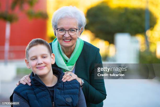 bonds beyond screens: teen and grandmother share quality time outdoors - fashionable grandma stock pictures, royalty-free photos & images