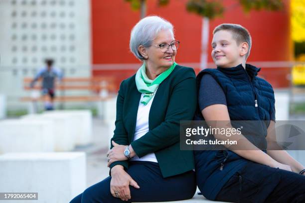 simple joys: teen and grandma embrace the beauty of shared moments - fashionable grandma stock pictures, royalty-free photos & images