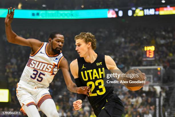 Kevin Durant of the Phoenix Suns derfends Lauri Markkanen of the Utah Jazz during the first half of a game at Delta Center on November 19, 2023 in...