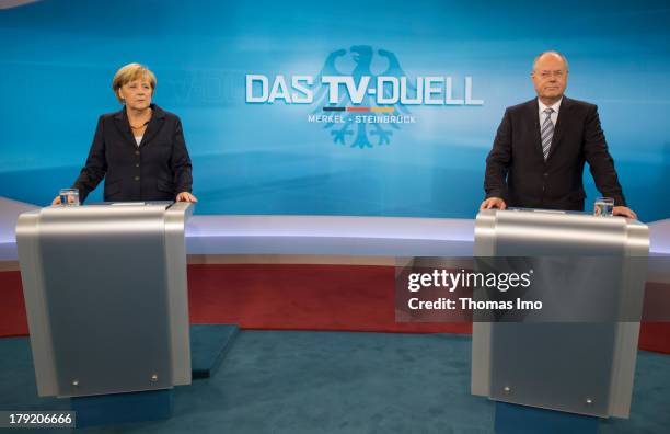 The Social Democratic Party's main candidate in upcoming parliamentary elections Peer Steinbrueck, and German Chancellor Angela Merkel poses for a...