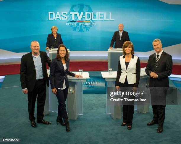 The Social Democratic Party's main candidate in upcoming parliamentary elections Peer Steinbrueck, and German Chancellor Angela Merkel poses for a...