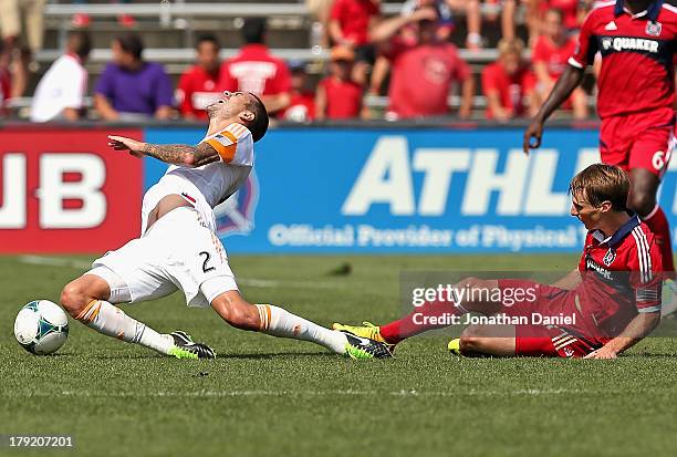 Chris Rolfe of the Chicago Fire takes down Eric Brunner of the Houston Dynamo during an MLS match at Toyota Park on September 1, 2013 in Bridgeview,...