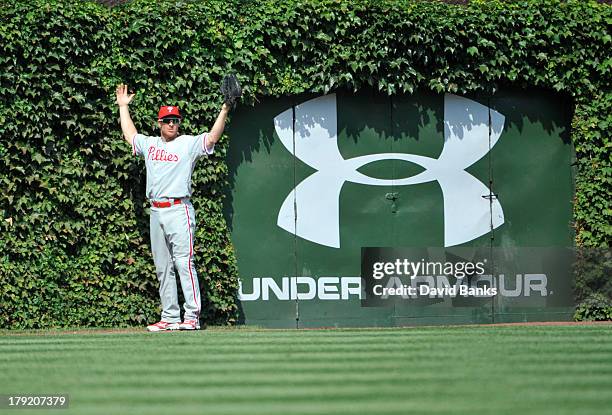 Pete Orr of the Philadelphia Phillies can't find a ground-rule double hit into the ivy by Brian Bogusevic of the Chicago Cubs during the fourth...