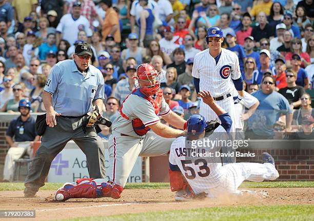 Welington Castillo of the Chicago Cubs slides safely into home as Erik Kratz of the Philadelphia Phillies can't handle the throw during the fourth...