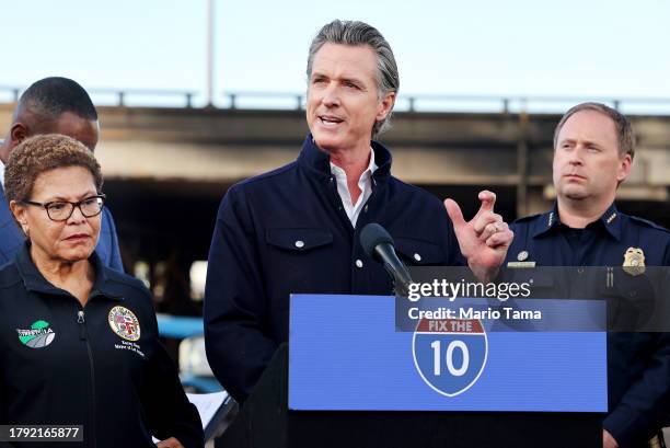 California Governor Gavin Newsom speaks as Los Angeles Mayor Karen Bass listens at a press conference near the closed I-10 elevated freeway following...