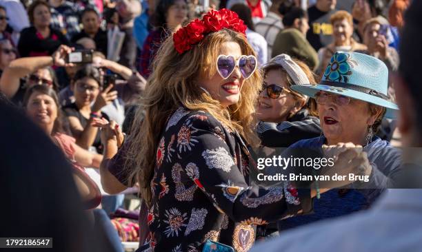 Los Angeles, CA Festival goers dance as mariachis play at the 34th anniversary Mariachi Festival and Feast of Santa Cecilia celebration on Sunday,...