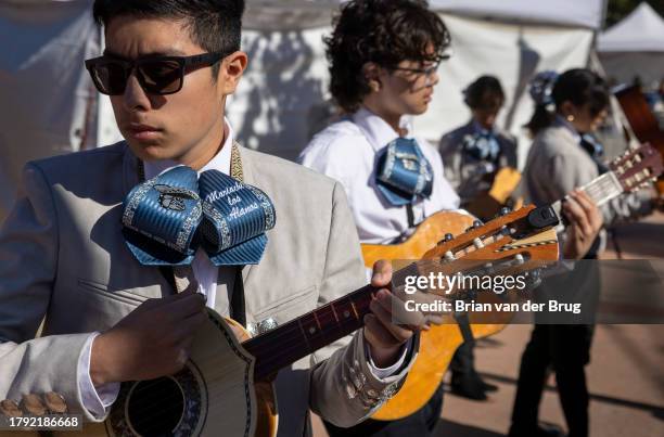 Los Angeles, CA Mariachi Los Alanos member Ian Magellanes, left, from Garfield High School warms up for the 34th anniversary Mariachi Festival and...