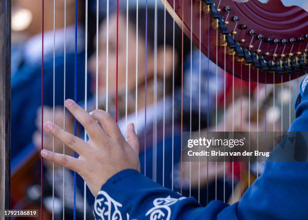 Los Angeles, CA A harpist during Mariachi Los Alanos from Garfield High School plays at the 34th anniversary Mariachi Festival and Feast of Santa...