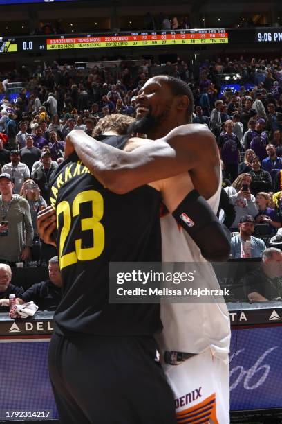 Lauri Markkanen of the Utah Jazz embraces Kevin Durant of the Phoenix Suns after the game on November 19, 2023 at Delta Center in Salt Lake City,...