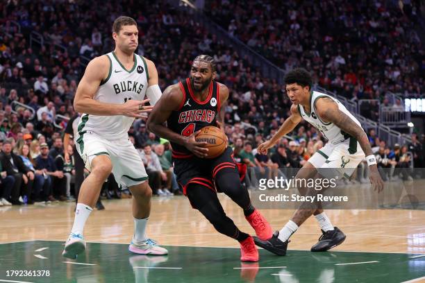 Patrick Williams of the Chicago Bulls drives around Brook Lopez of the Milwaukee Bucks during the first half of a game at Fiserv Forum on November...