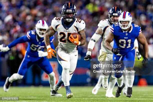 Samaje Perine of the Denver Broncos runs the ball during the game against the Buffalo Bills at Highmark Stadium on November 13, 2023 in Buffalo, New...