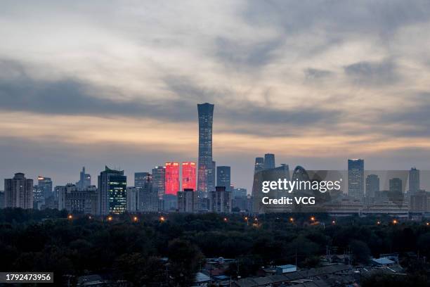 Illuminated skyscrapers stand at the central business district at sunset on November 13, 2023 in Beijing, China.