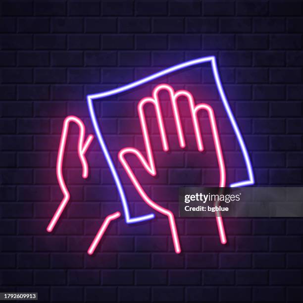 clean and sanitize hands with wipes. glowing neon icon on brick wall background - kitchen paper stock illustrations