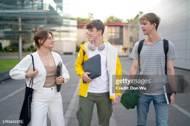 three students walking on campus - medical school building stock pictures, royalty-free photos & images